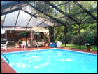 Bronze, Free-Standing, Gable-Hip Style Pool Enclosure with side gable sun-screen to block afternoon sun